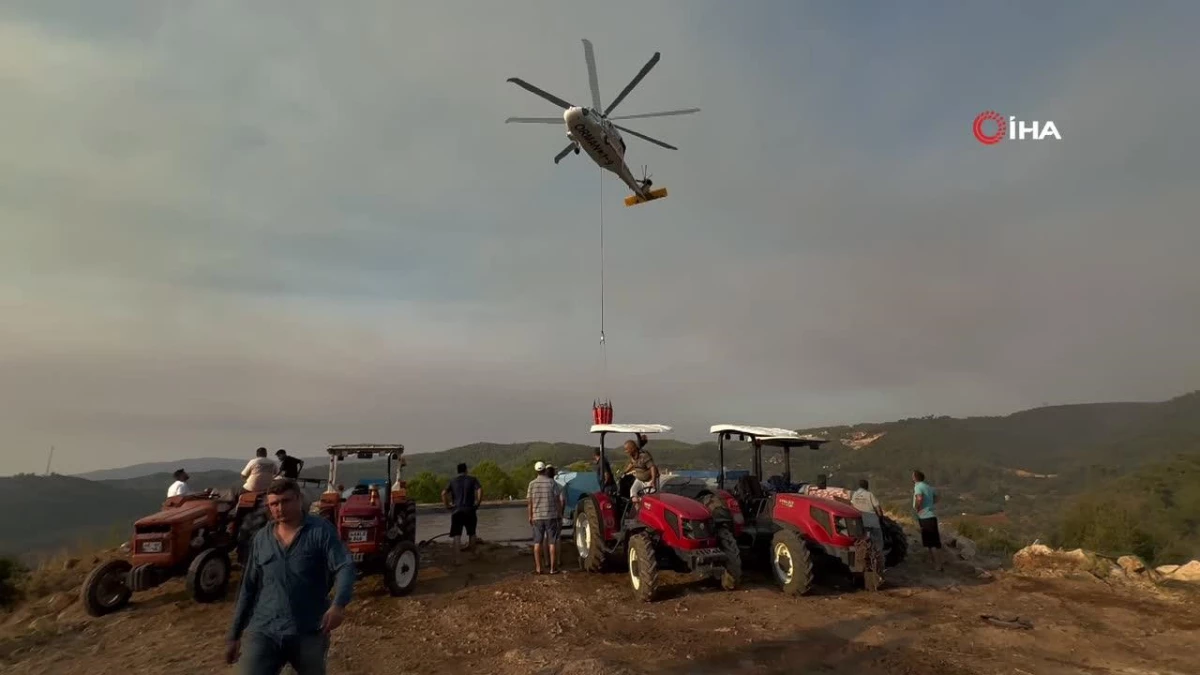 Köylüler yangına karşı seferber oldu: Tankerlerle helikopterlere su takviyesi
